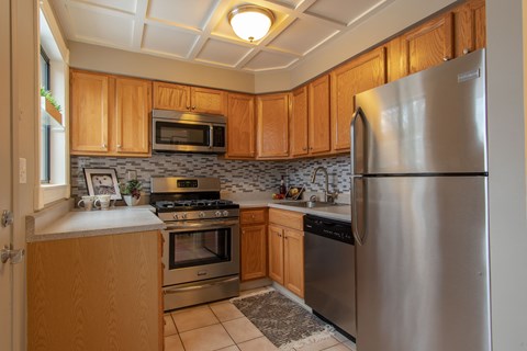 a kitchen with stainless steel appliances and wooden cabinets
