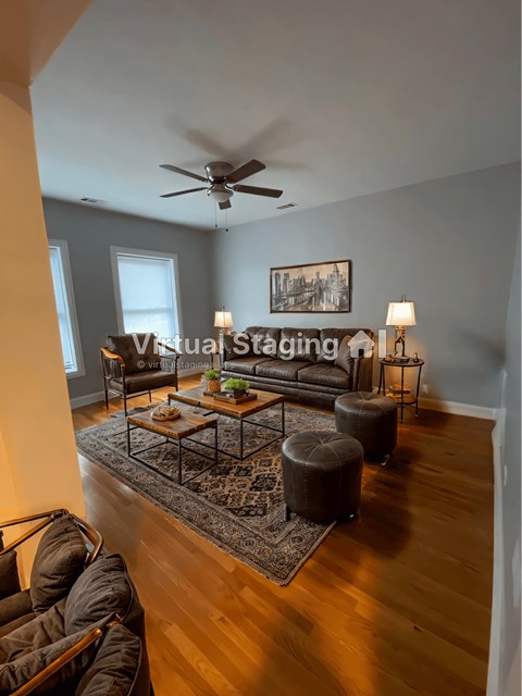 a living room with a couch and a ceiling fan