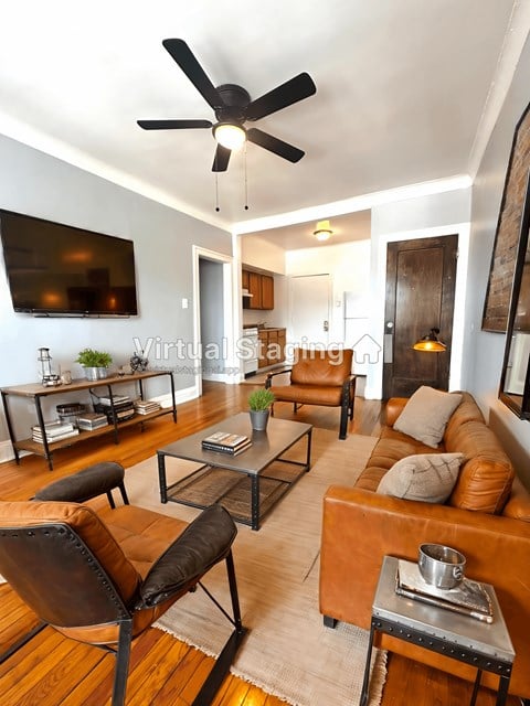 a living room with leather furniture and a tv