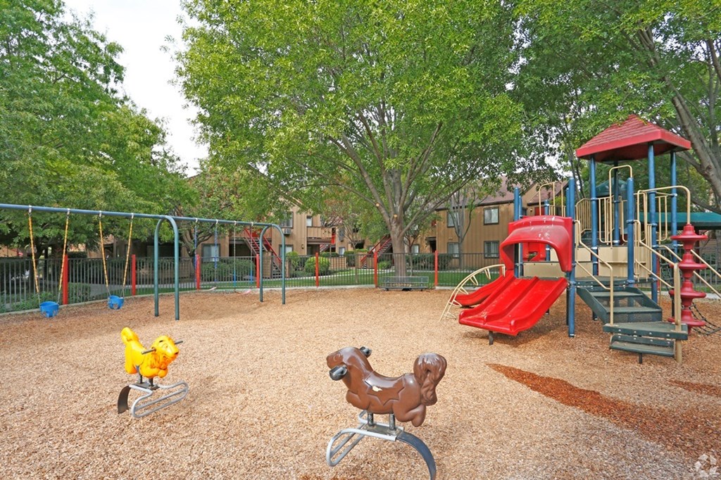 CCV playground with a red slide and a brown rocking horse.