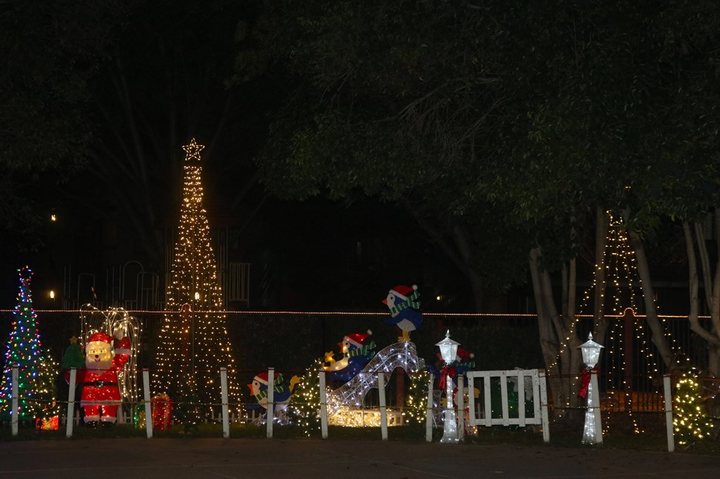 A Christmas display with a large tree and a snowman.