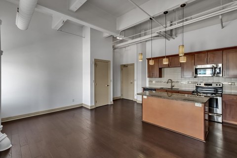 A kitchen area with a stainless steel counter and a microwave.