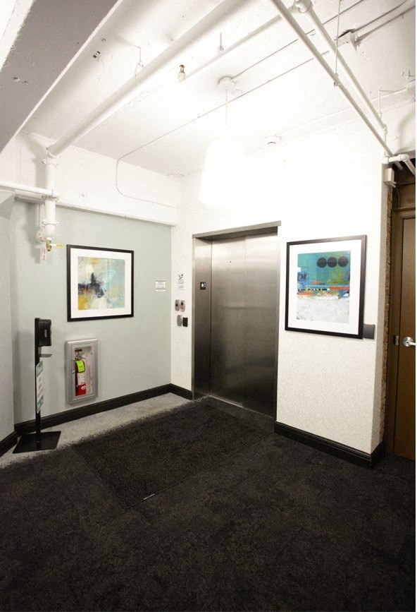 a room with a door and pictures on the wall