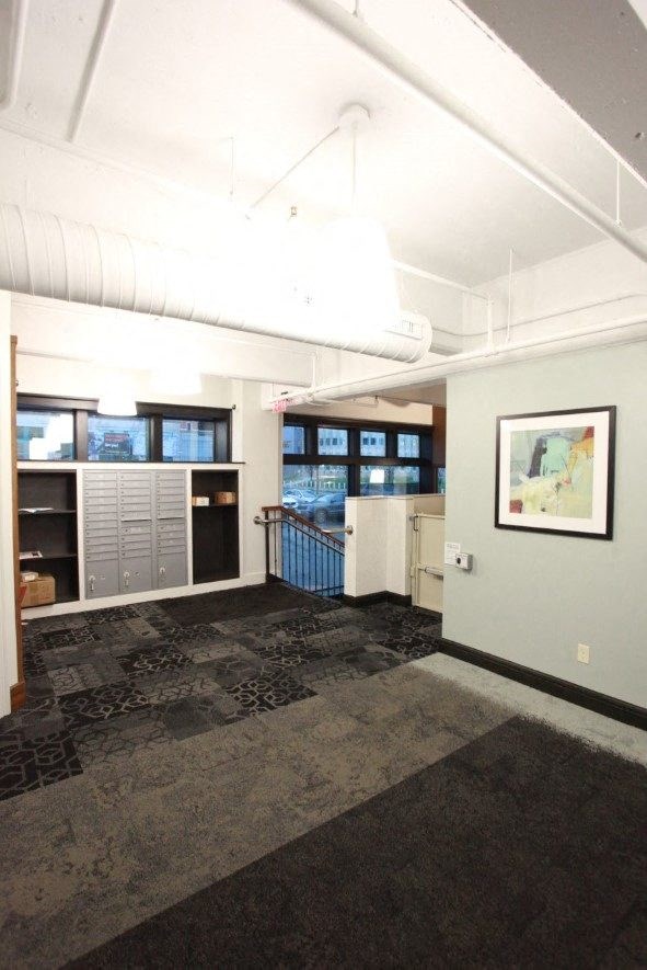 a living room with a kitchen and a staircase