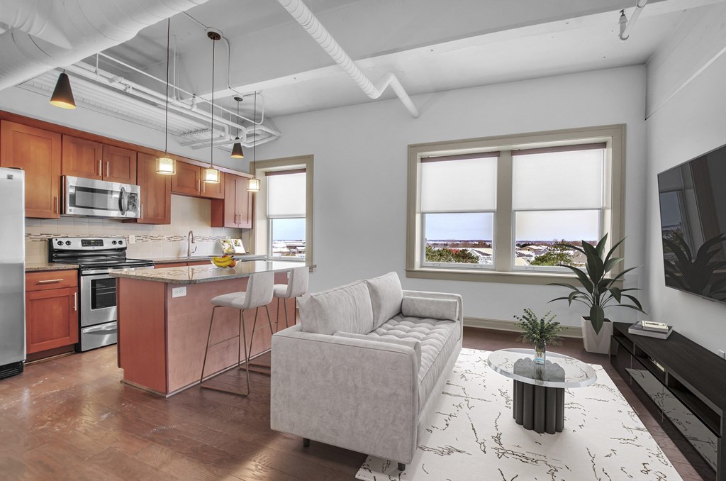 A modern kitchen with a white ceiling and a large window. at 100 South Apartments, Buffalo, NY