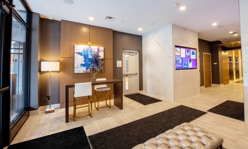a lobby with a table and chairs and a tv