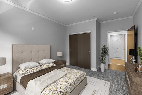 A bedroom with a large bed and a wooden headboard.