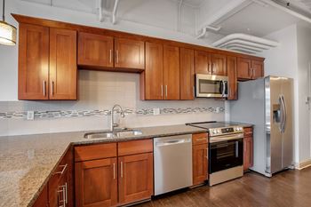 A kitchen with wooden cabinets and stainless steel appliances.