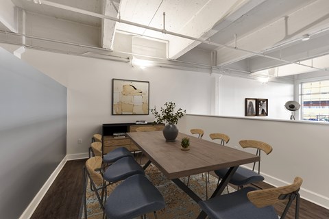 A conference room with a long table and chairs.