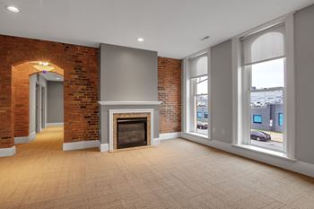 A room with a fireplace and brick walls.