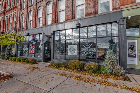A building with a glass window and a sign that says "Gardening Ace".