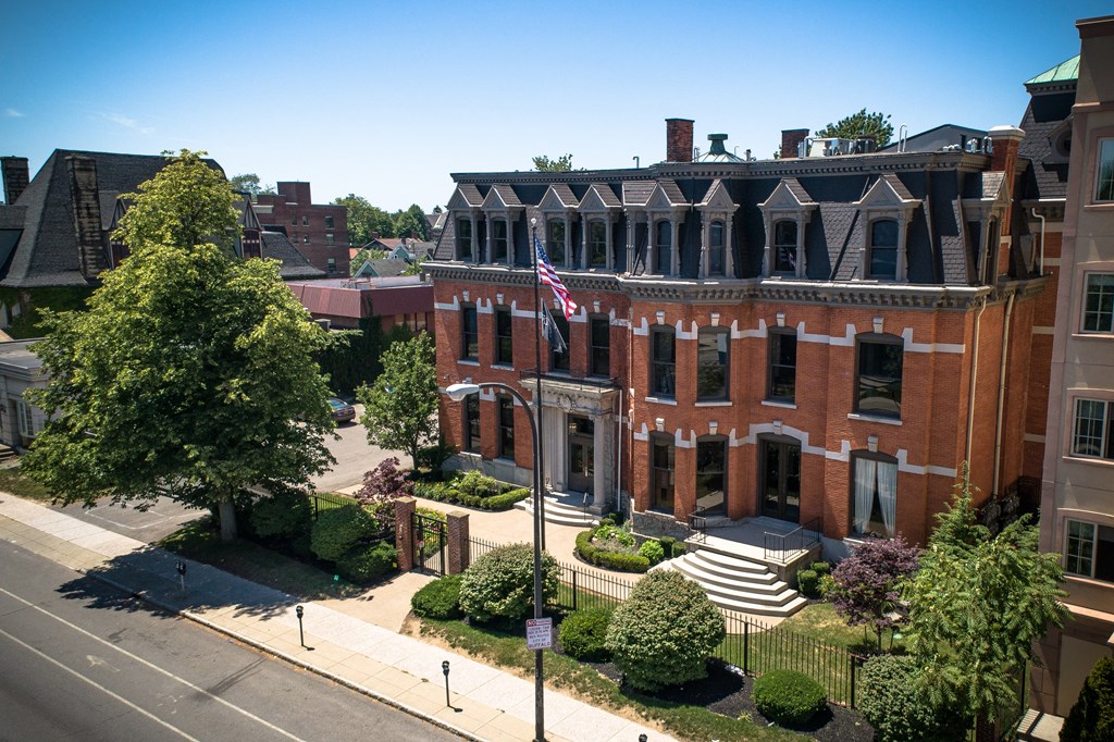 an aerial view of a red brick building with an flag