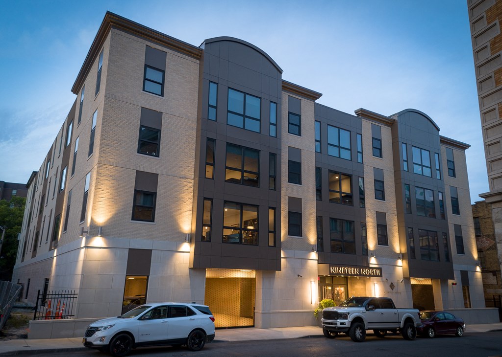 a building with two cars parked in front of it