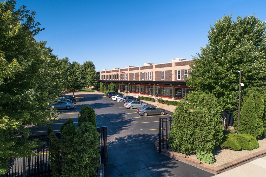 an aerial view of a building with cars parked in a parking lot at The Lofts at Elk Terminal, Buffalo, NY, New York, 14204