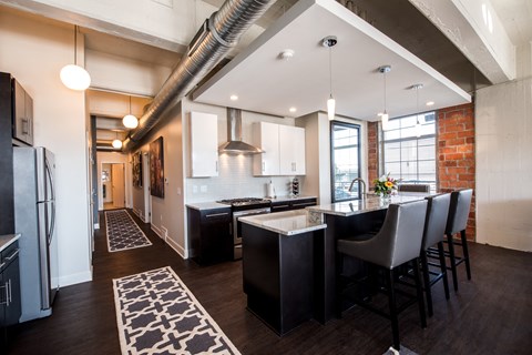 a large kitchen with a bar and a dining table
