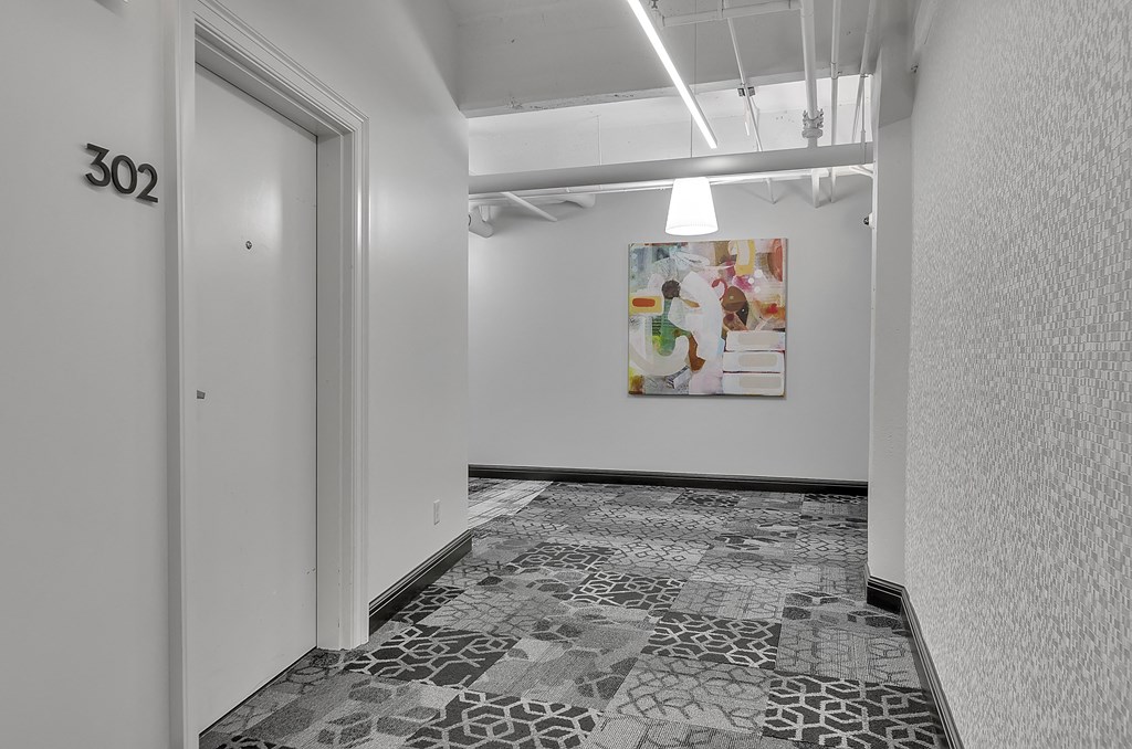 a room with a door and a painting on the wall at 100 South Apartments, Buffalo