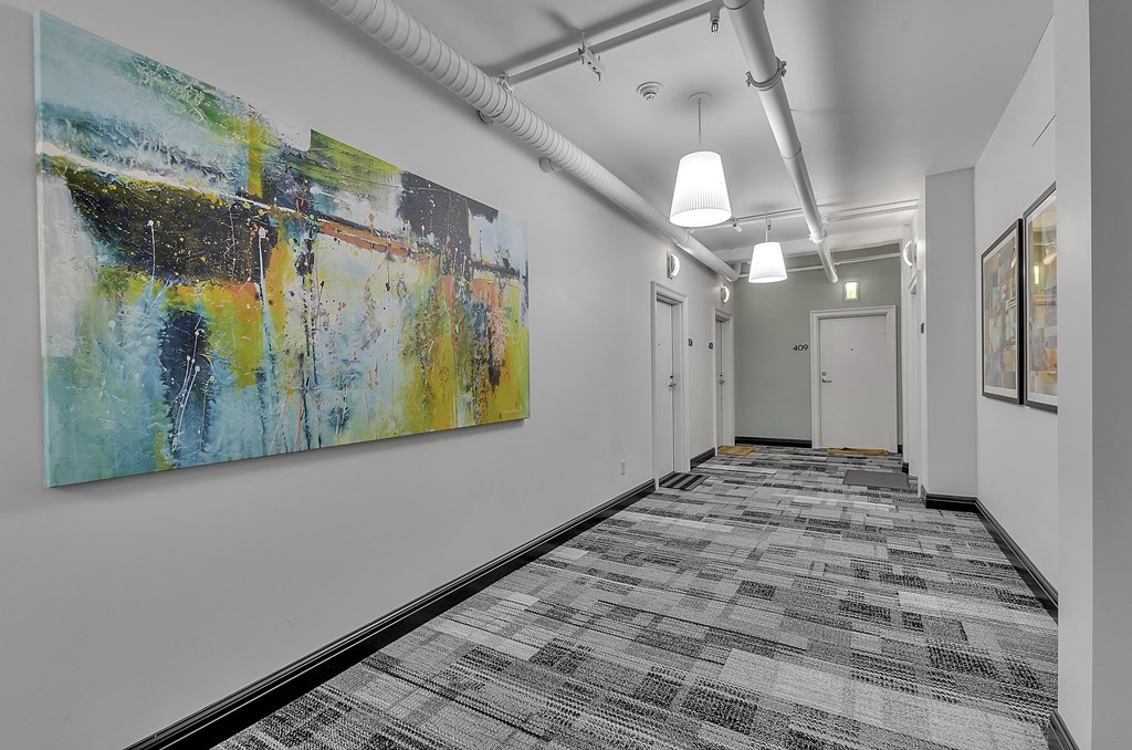 office space with artwork on the wall and hallway with white doors at 100 South Apartments, Buffalo, 14202