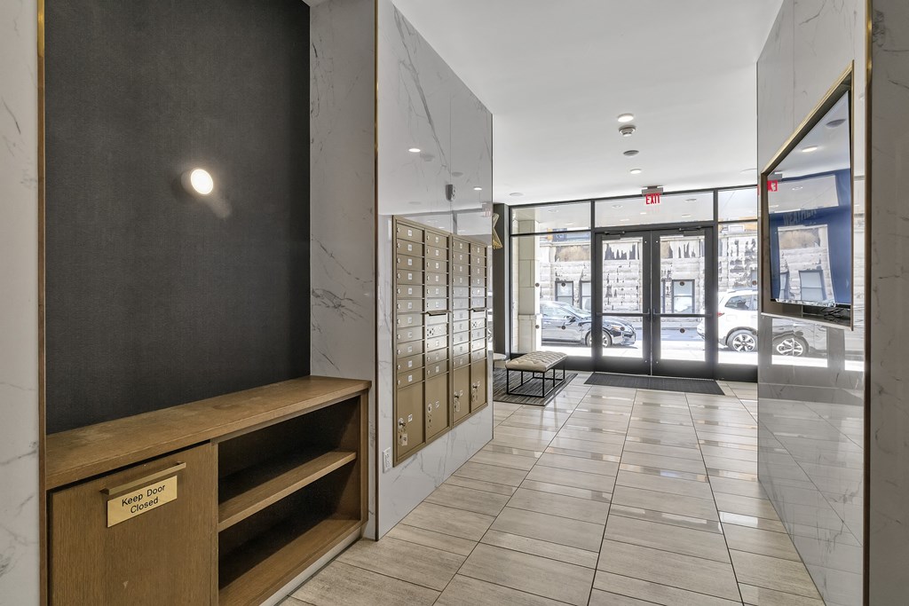 a hallway with a desk and a door to a building at Nineteen North, New York