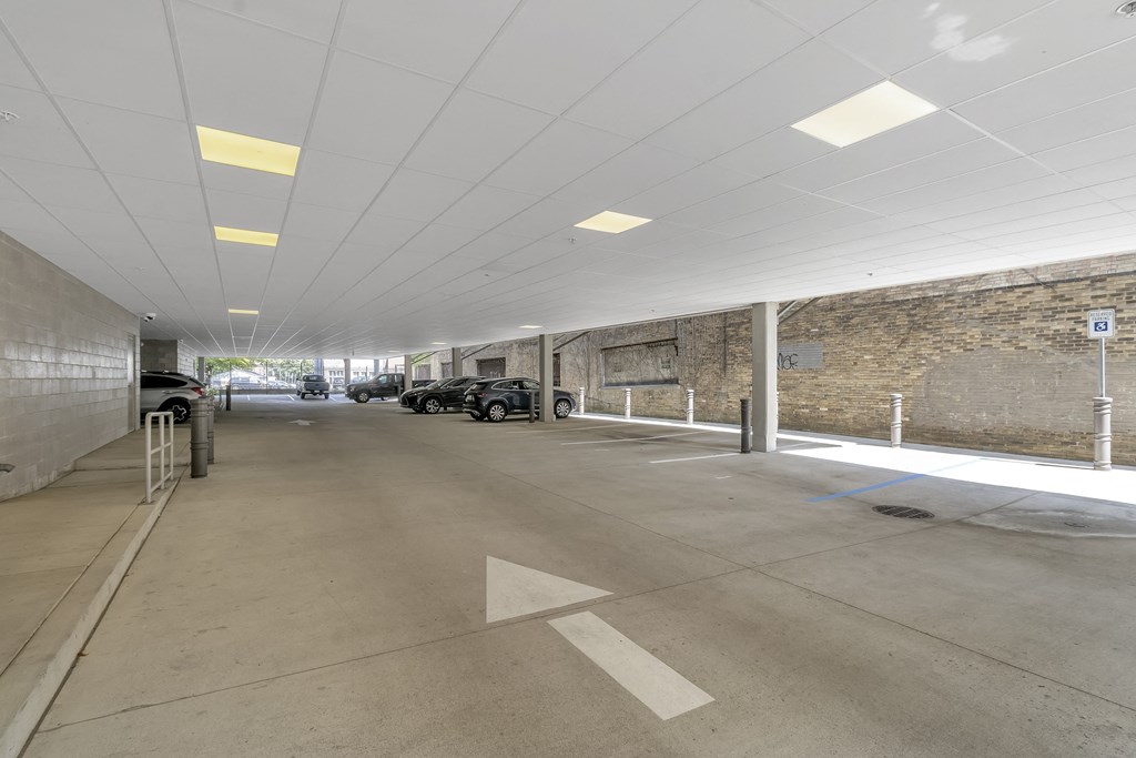 a parking garage with cars and a brick wall at Nineteen North, Buffalo, NY