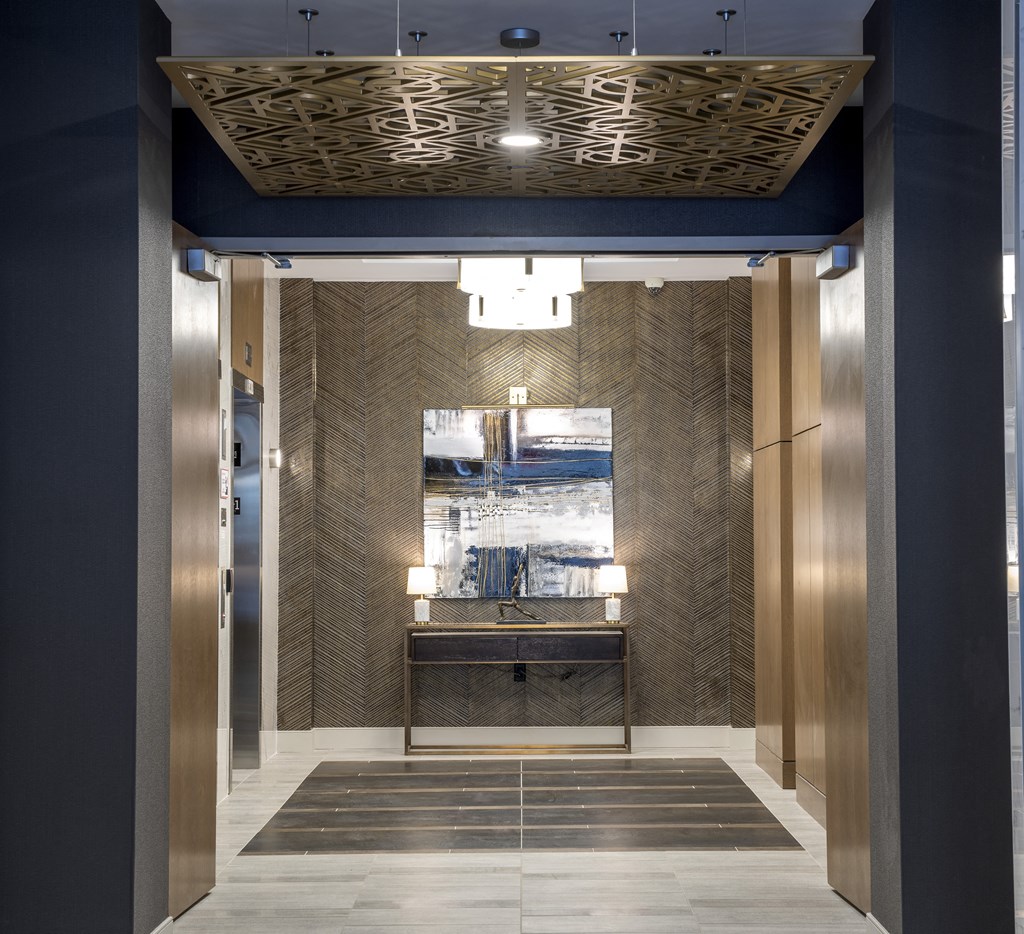 a view of the elevator lobby of a building with a blue and gold elevator lobby at Nineteen North, New York, 14202