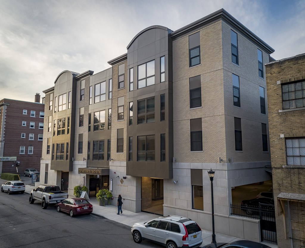 a new apartment building on a city street with cars at Nineteen North, Buffalo