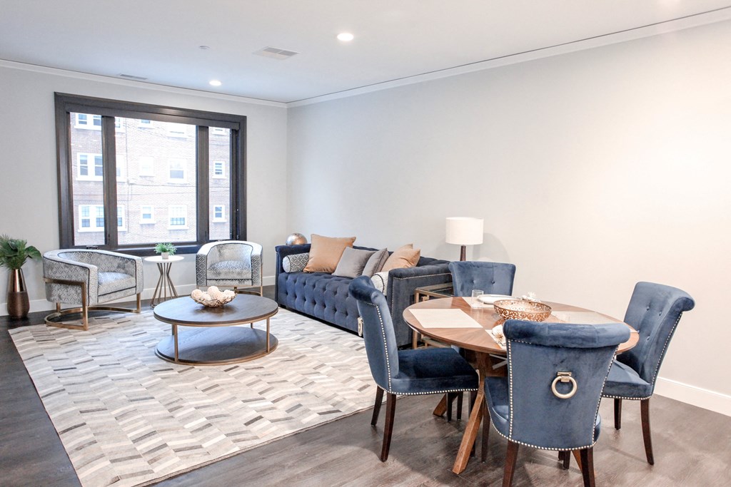 a living room with couches and chairs and a table
