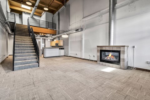 Two story loft with staircase and fireplace at The Lofts at Elk Terminal Apartments, Buffalo