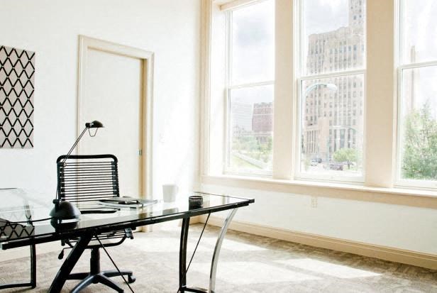 a office with a glass table and a chair