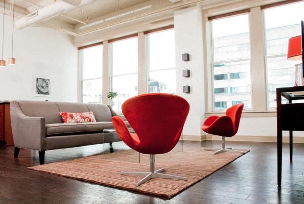 a living room with a couch and chairs and a rug