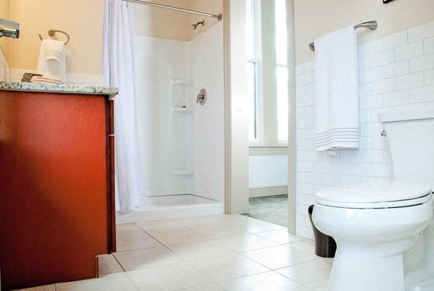 a bathroom with a toilet and a sink and a shower