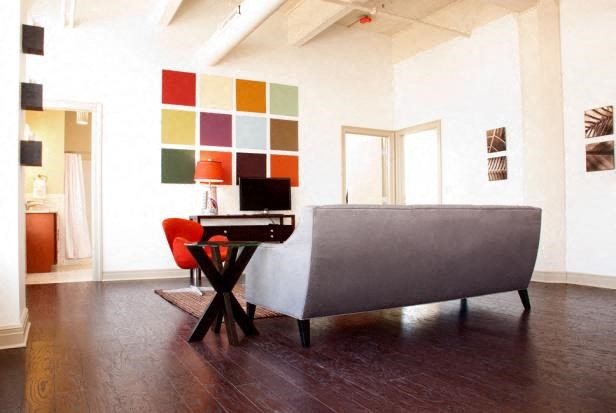 a living room with a couch and a desk