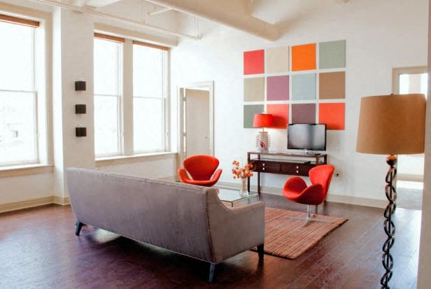 a living room with a couch and chairs and a television