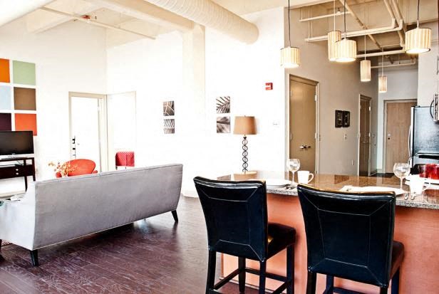 a living room with a couch and a table and chairs