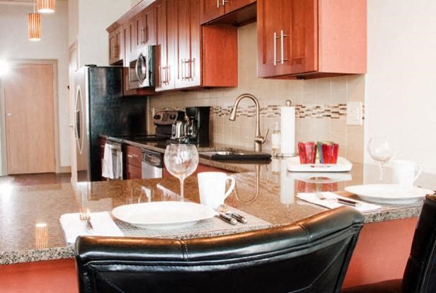 a kitchen with a table and a chair