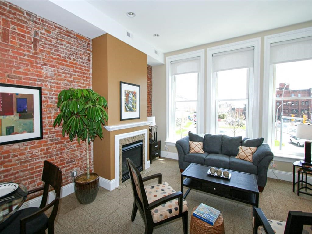 a living room with a couch and a brick wall