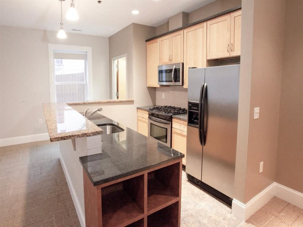 a kitchen with stainless steel appliances and a counter top