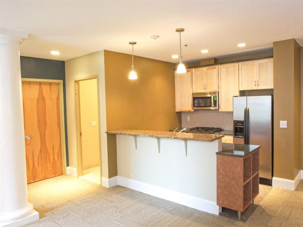 a kitchen with a counter top and a refrigerator