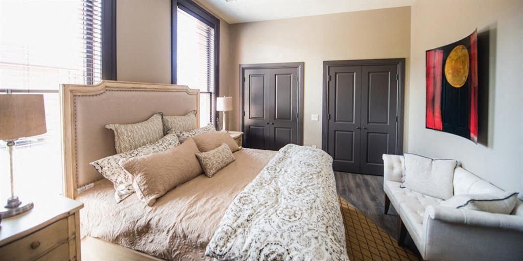 a bedroom with a bed and a couch and a window