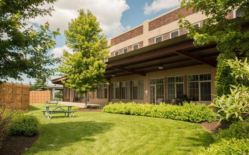 a building with a picnic table in the grass