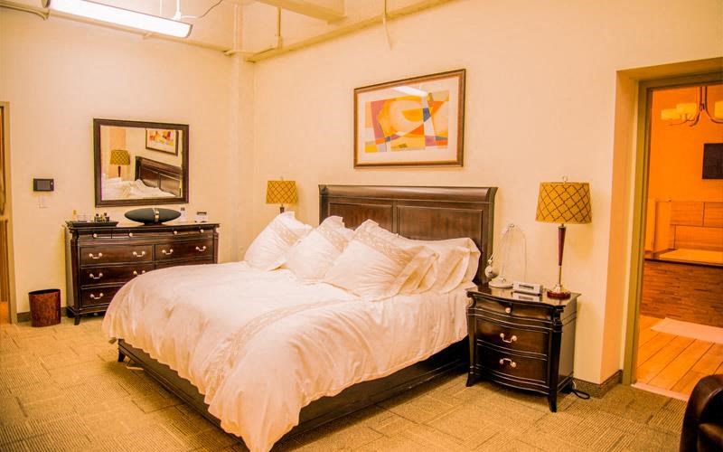 a bedroom with a bed and two night stands