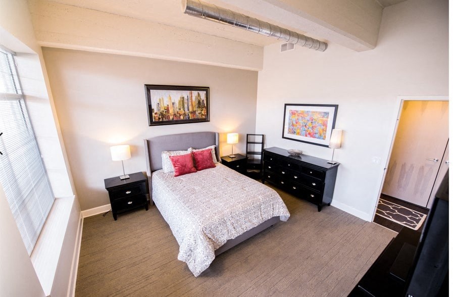 a bedroom with a bed and two night stands