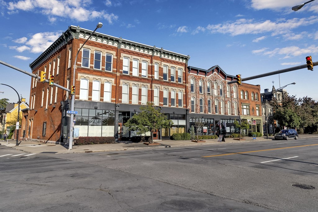 a large brick building on the corner of a city street at The Granite Works Apartments , Buffalo, NY