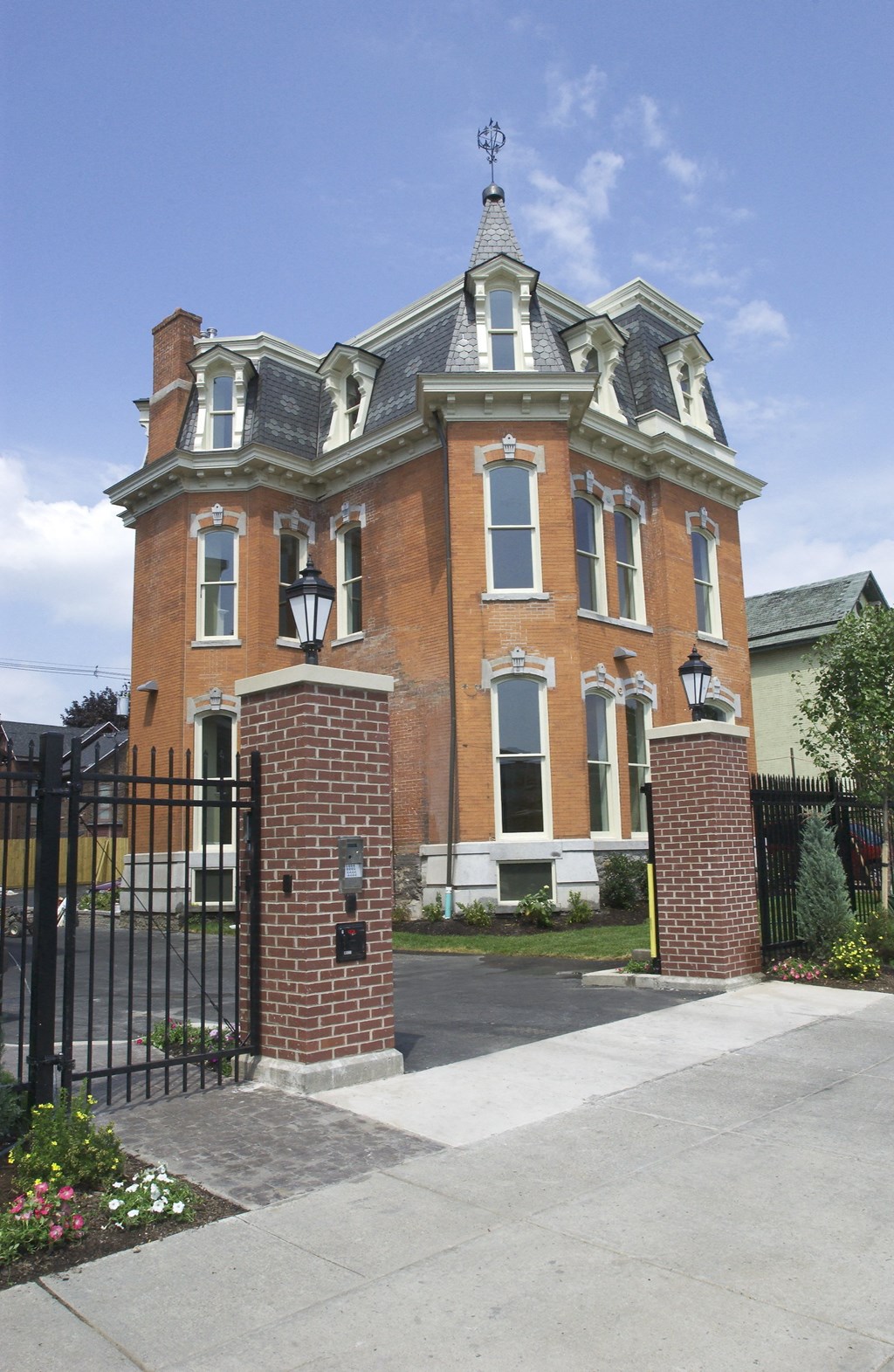 a red brick house with a black wrought iron gate a red brick house with a black wrought iron gate at The Granite Works Apartments , Buffalo