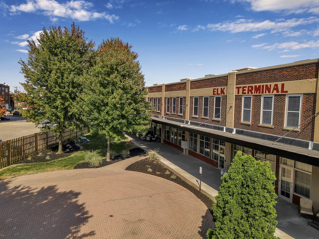 an aerial view of a building with trees and a sidewalk at The Lofts at Elk Terminal, Buffalo, 14204