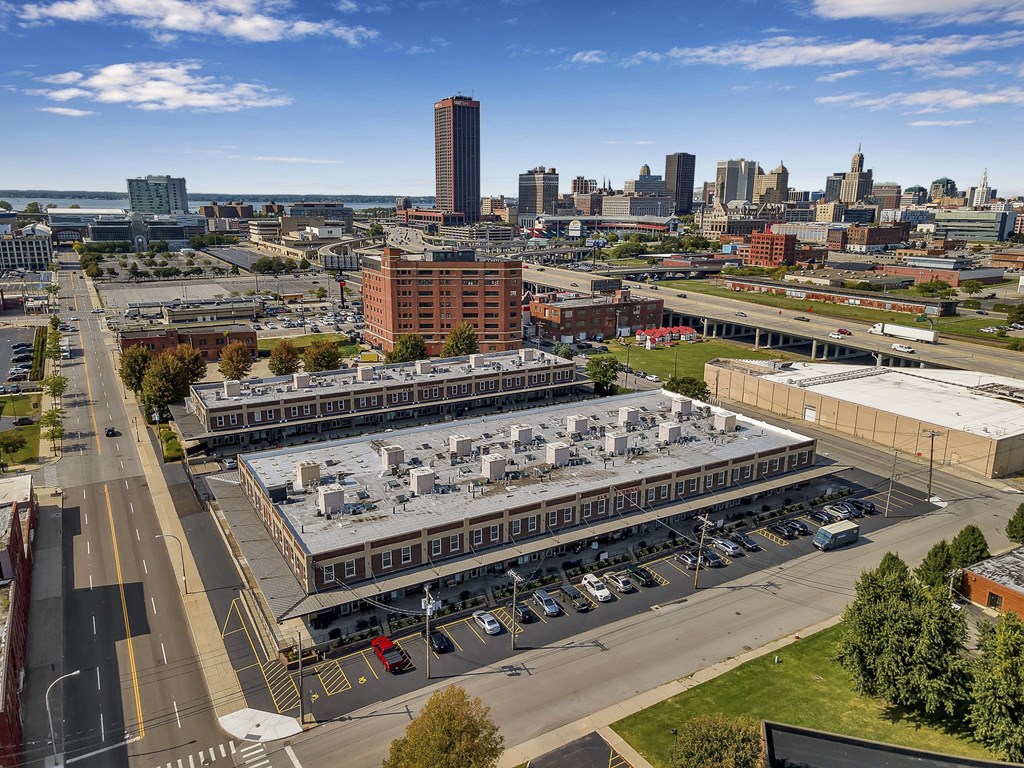 an aerial view of a large building with a city in the background at The Lofts at Elk Terminal, Buffalo, New York