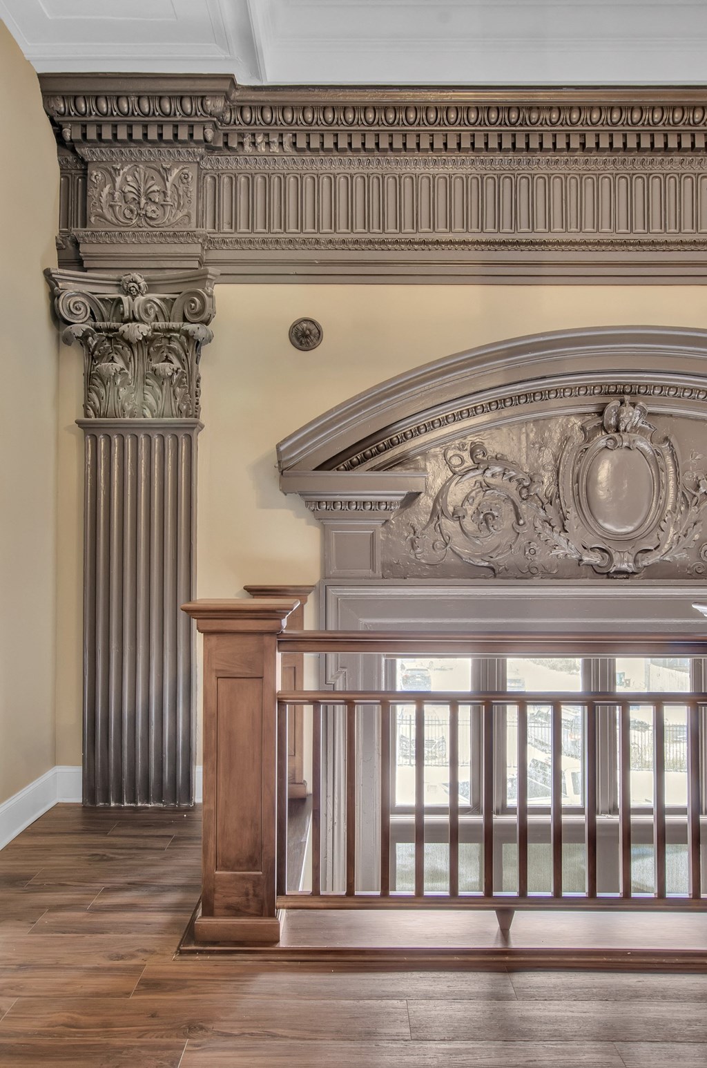 A balcony with a railing and a column with a decorative capital. at The Knights @ 506 Delaware Apartments, Buffalo, New York