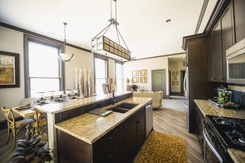 a kitchen and living room with a large counter top