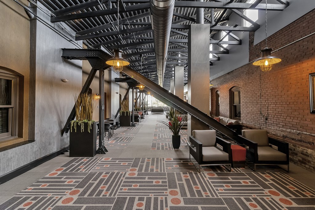 a lobby with a large staircase and a rug on the floor at The Knights @ 506 Delaware Apartments, New York