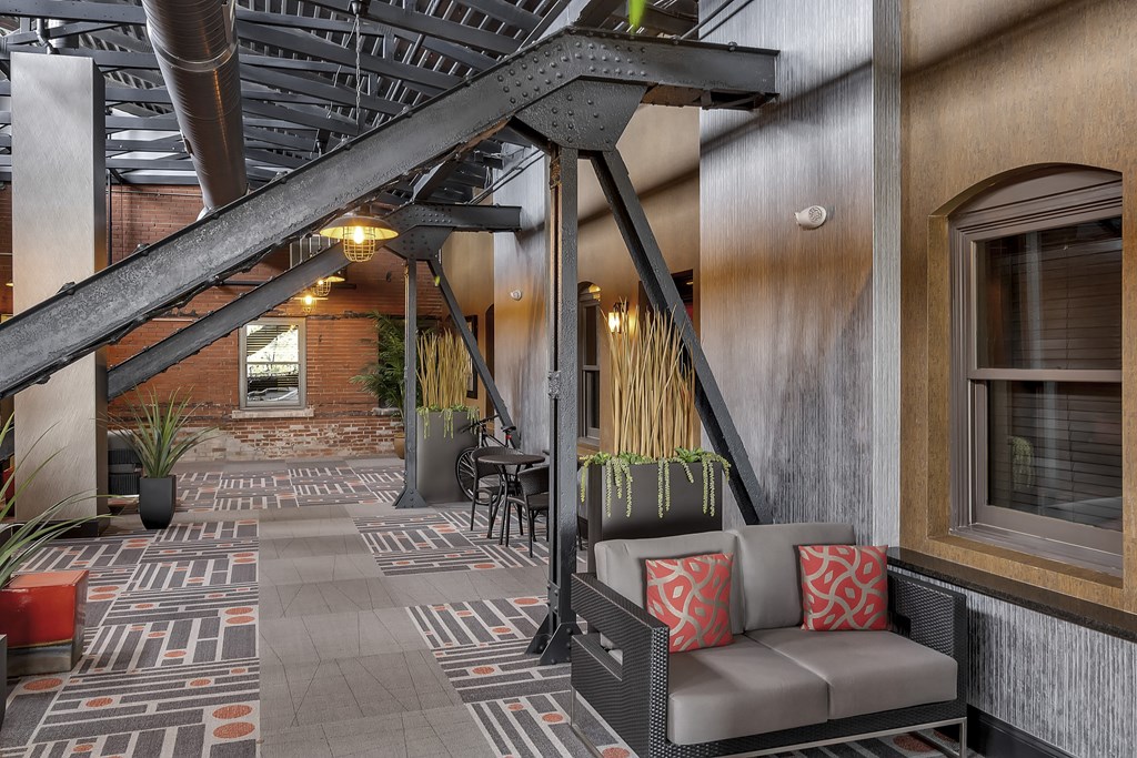 a lobby with a seating area and a staircase at The Knights @ 506 Delaware Apartments, Buffalo