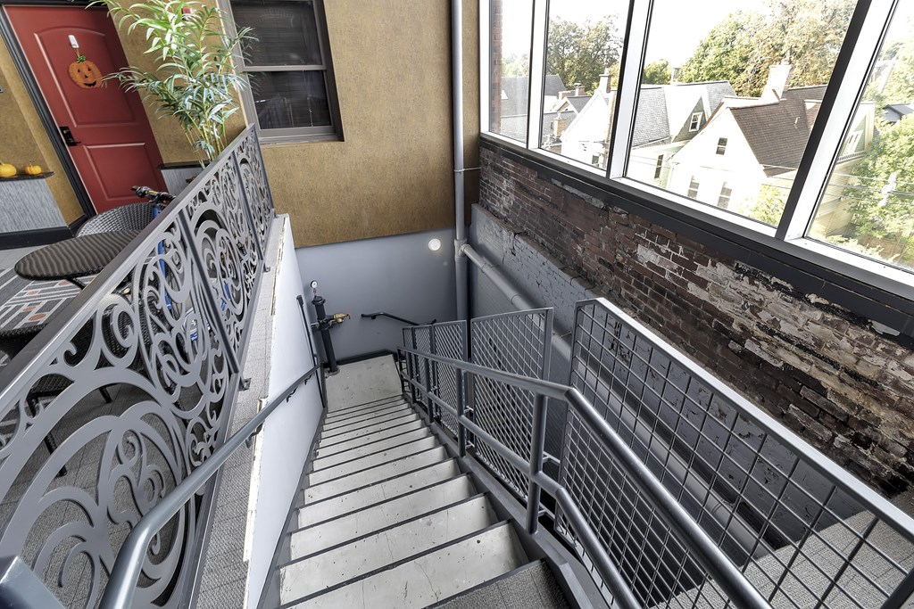 a view of the balcony with stairs and a brick wall at The Knights @ 506 Delaware Apartments, New York, 14202